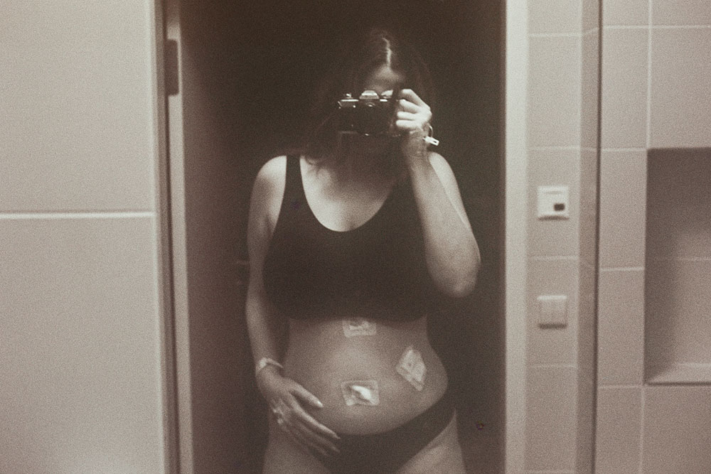Self portrait of Mariam Mekiwi in front of a hospital mirror