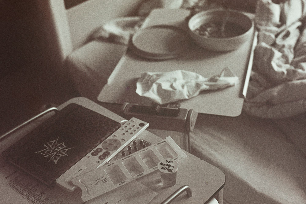 Photo of hospital bed with food tray and other patient affairs