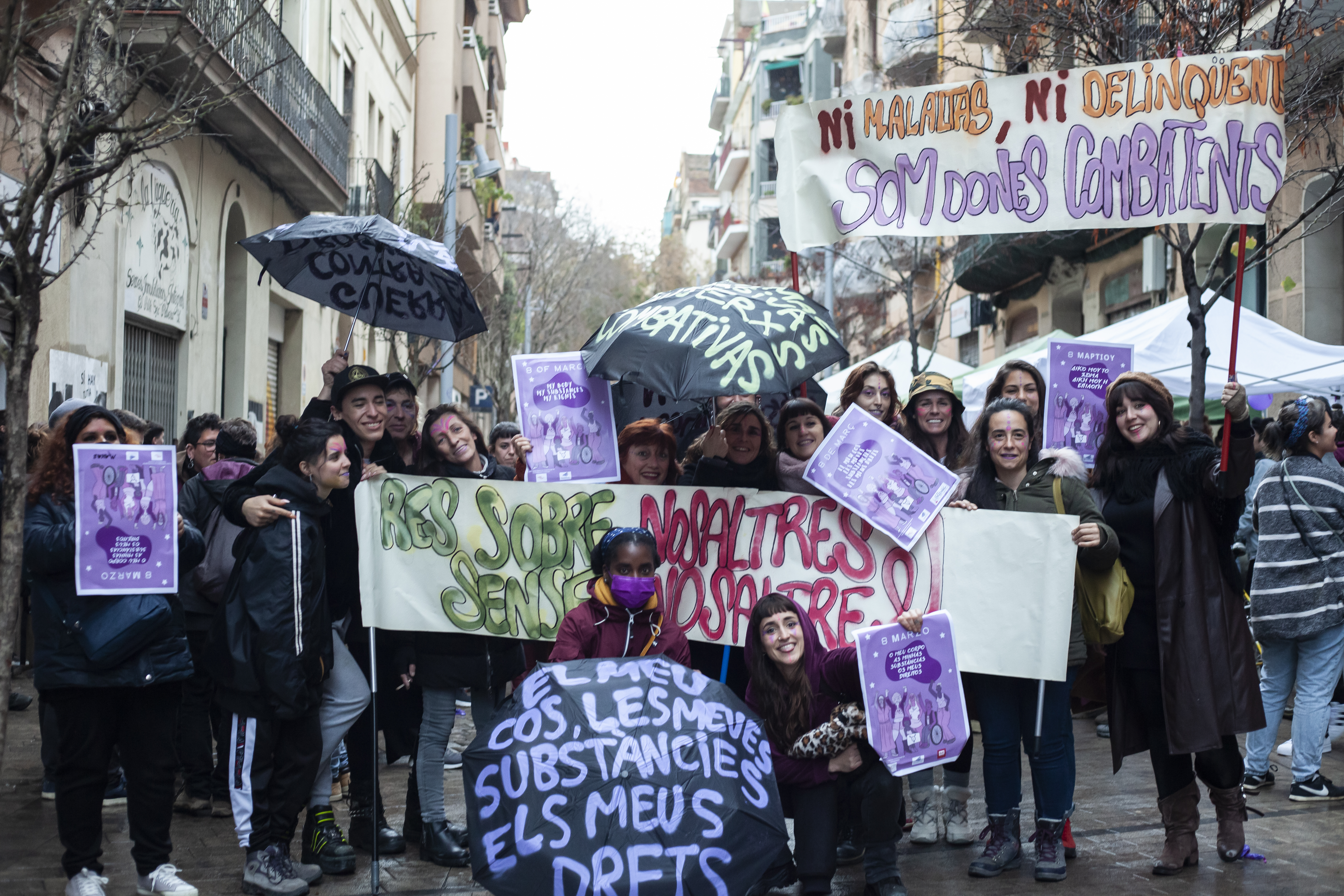 Group of activists standing on the street holding banners and signs