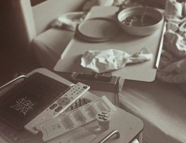 Photo of hospital bed with food tray and other patient affairs