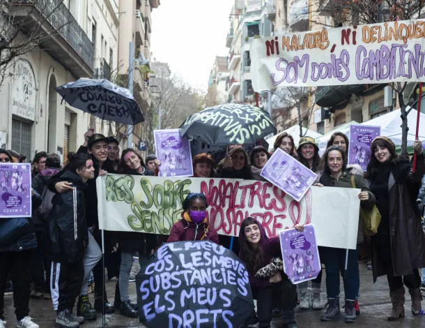 Group of activists standing on the street holding banners and signs