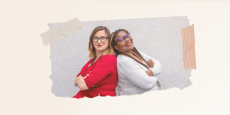 Inna Michaeli and Faye Macheke sitting back to back, smiling.    