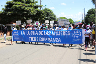 People demonstrating and holding a long blue poster