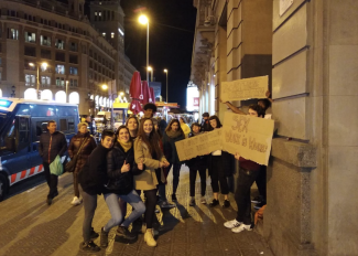 Photo of a group of people at night demonstrating.