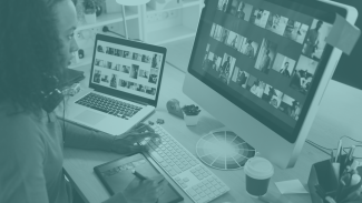 Image of a woman working on a desk, with two screens and a color wheel in a design project.